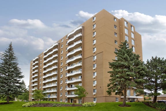 an apartment building on a cloudy day with trees