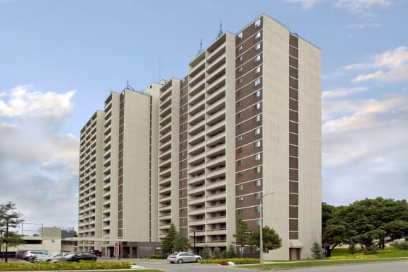 a tall building with many windows and a street in front of it