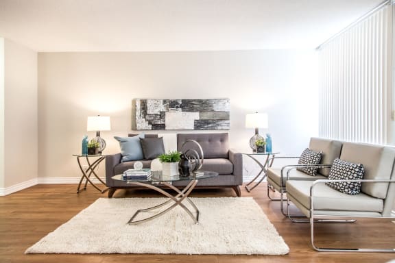 a living room with a couch and chairs and a table