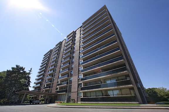 an apartment building with a blue sky in the background