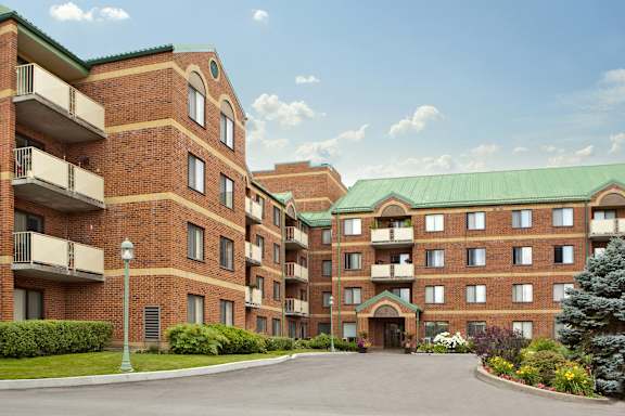 a large brick building with a street in front of it