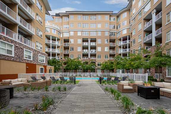 an apartment building with a swimming pool in the middle