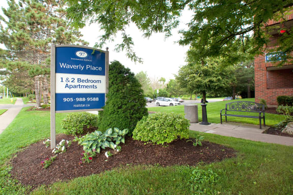 a sign forwy place in front of a park