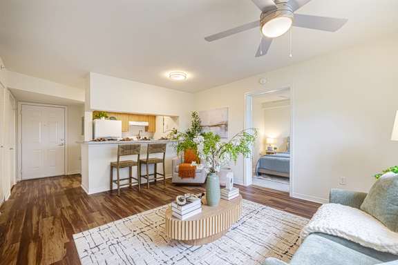 a couple sitting on a couch with their dog at Heron Pond 55+ Apartments, Lehigh Acres, FL, 33972