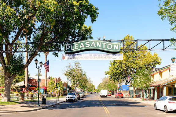 a city street with a sign for pleasanton at Pleasanton Place, Pleasanton, California