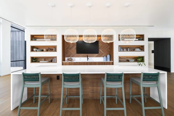 a rendering of a kitchen with a counter and chairs