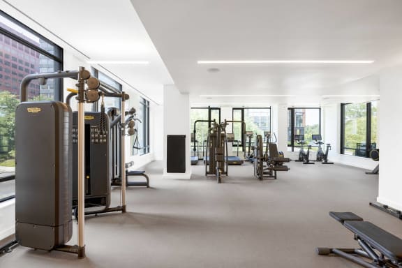 a gym with a lot of exercise equipment and windows