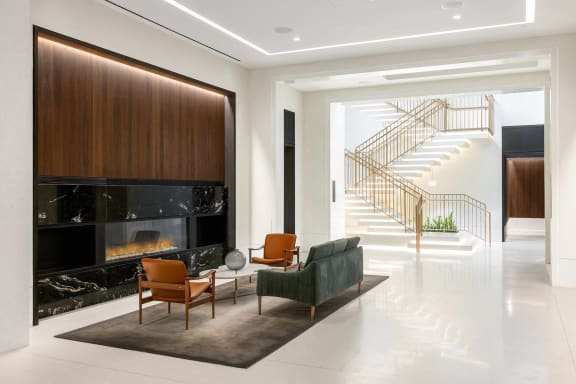a living room with a fireplace and a staircase