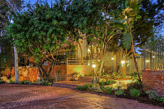 A house surrounded by trees at night.