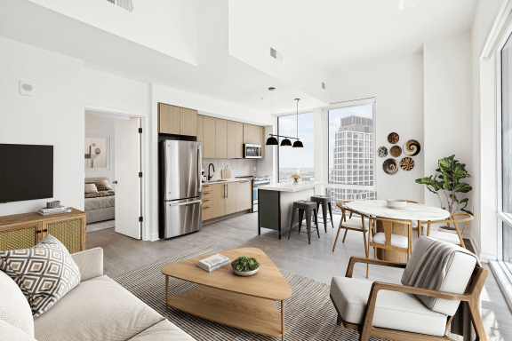 a living room with a couch and a table and a kitchen