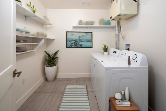 a laundry room with a washer and dryer and a sink