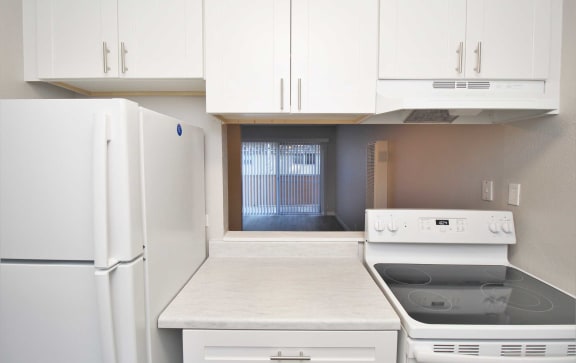 a kitchen with white appliances and white cabinets