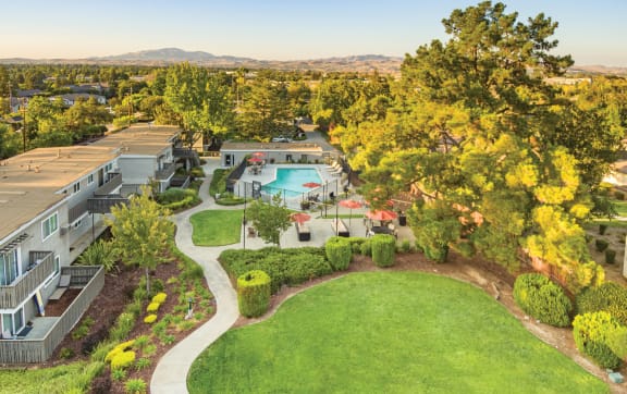 a aerial view of a yard with a pool and buildings  at Pleasanton Heights, California