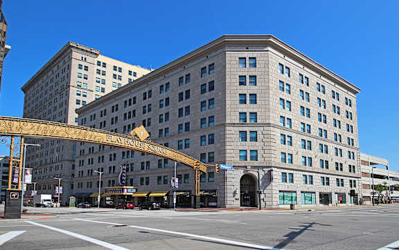 A large building with a yellow archway in front of it.