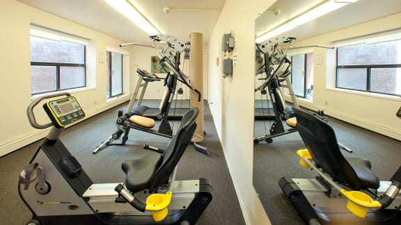 two different views of a gym with exercise equipment