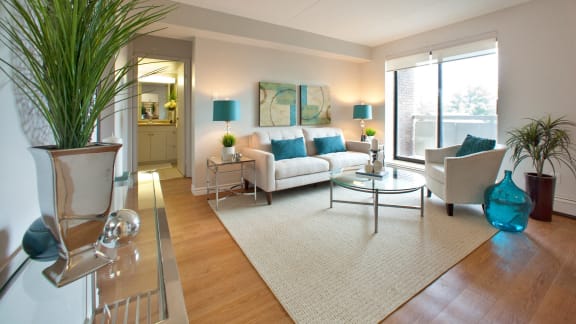 a living room with a white couch and a glass table