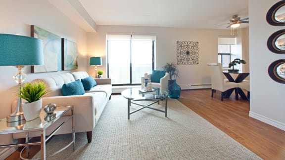 a living room with a white couch and a glass coffee table
