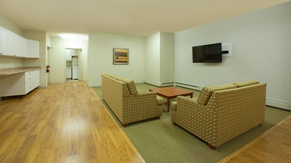 a living room with couches and a table and a television