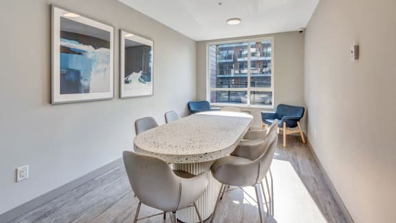a dining room with a table and chairs and a window