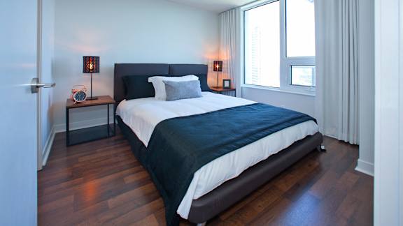 a bedroom with a bed and a window