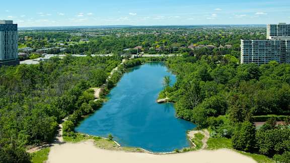 a view of a lake in a city with trees and buildings