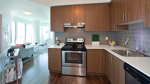 a modern kitchen with stainless steel appliances and wooden cabinets