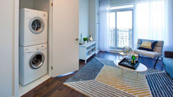 a living room with a washing machine and a washer and dryer in it