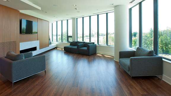 a living room with couches and a wall of windows