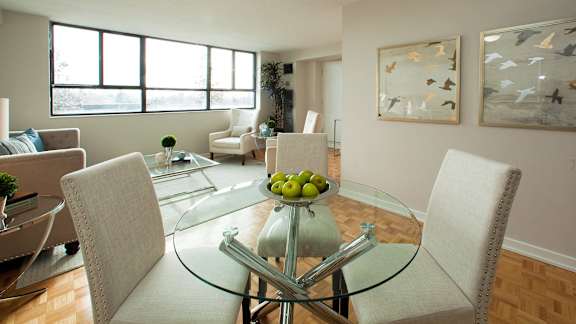 a dining room with a glass table and chairs