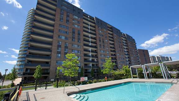 a swimming pool in front of an apartment building
