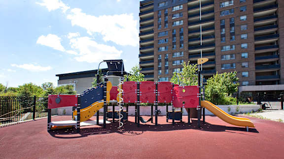 a playground in a city with tall buildings