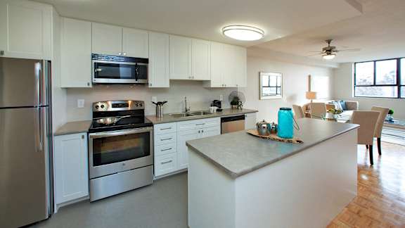 a kitchen with a center island and stainless steel appliances