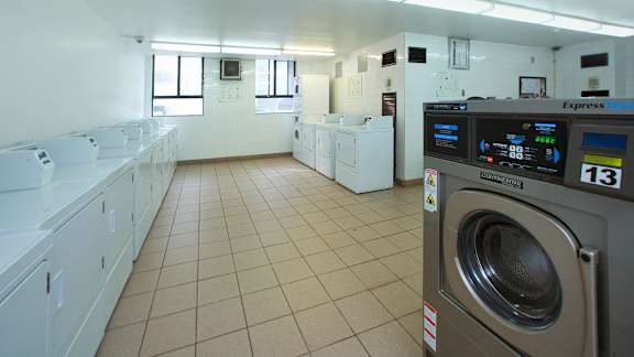 a washer and dryer in a laundry room with whitewashers and sinks