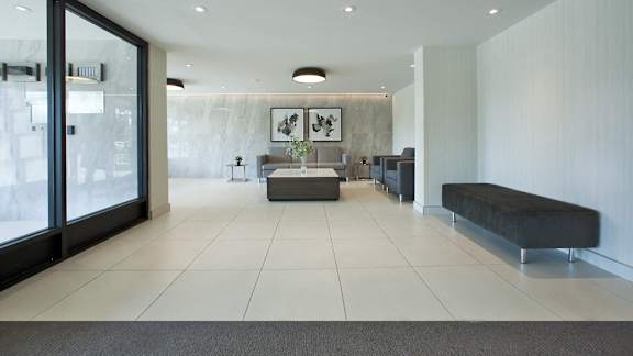 a lobby with a seating area and a glass door