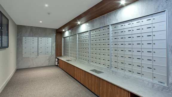 a locker room with lockers and mailboxes on the wall