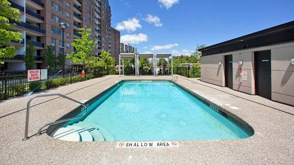 a swimming pool with a building in the background