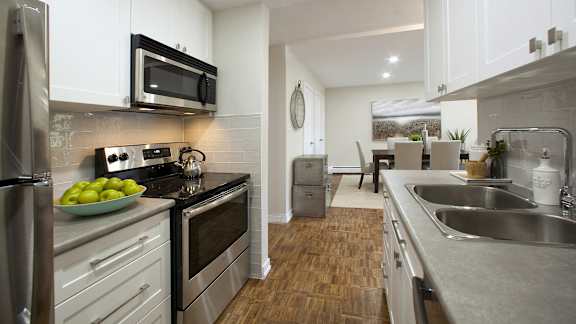 a kitchen with stainless steel appliances and white cabinets