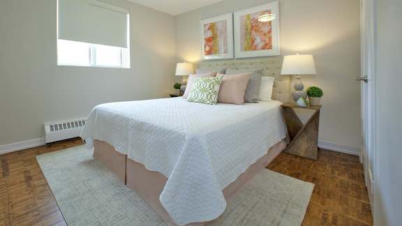 a bedroom with a white bed and a window