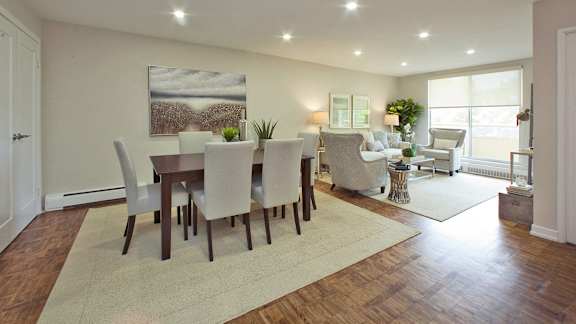 a dining room and living room with a table and chairs