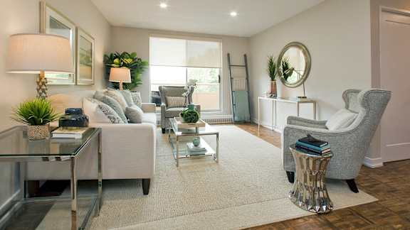 a living room with couches and chairs and a table