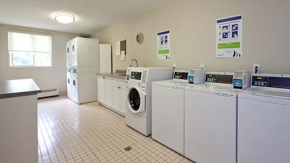 an image of a laundry room with washing machines and refrigerators
