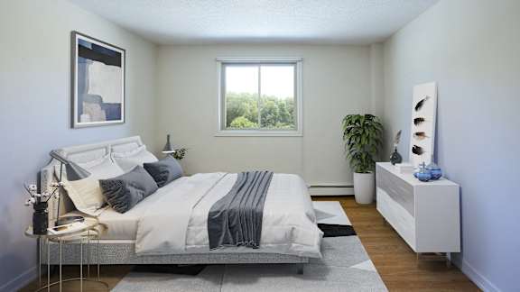 a white bedroom with a bed and a window