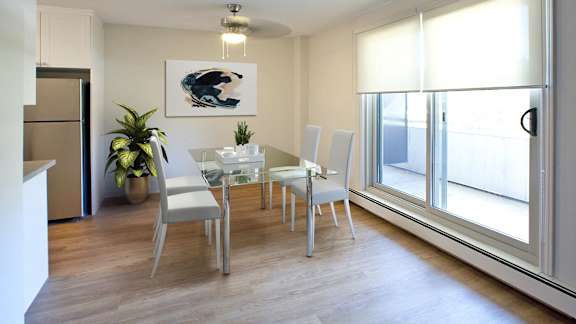 a dining room with a table and chairs and a window