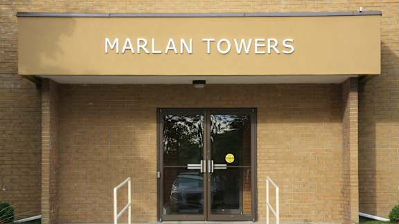 the front door of the marian towers building