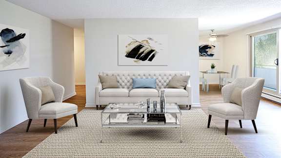 a living room with white furniture and a glass coffee table