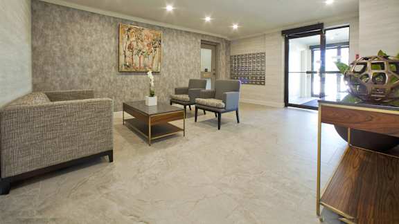a living room with a couch and chairs and a table