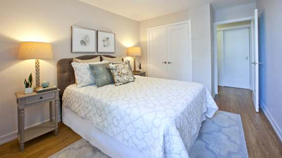 a bedroom with a large bed and a door to a bathroom