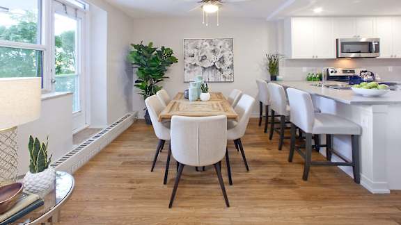 a dining room and kitchen with a table and chairs