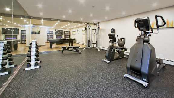 the gym is equipped with fitness equipment including treadmills and weights