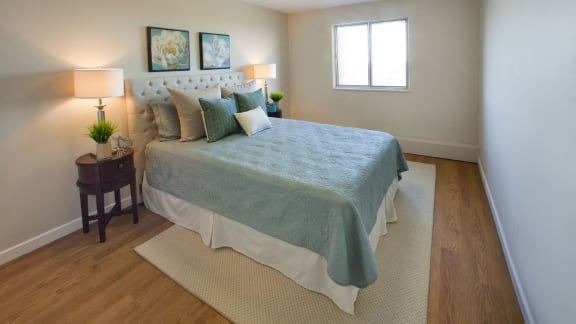a bedroom with a large bed and a window